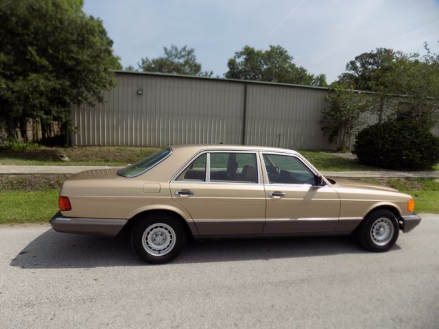 1984 champagne pearl Mercedes-Benz 500-Series sedan