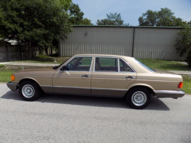 1984 champagne pearl Mercedes-Benz 500-Series sedan