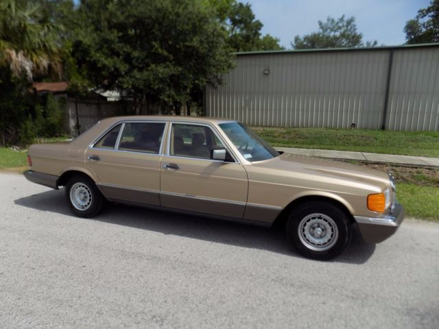 1984 champagne pearl Mercedes-Benz 500-Series sedan
