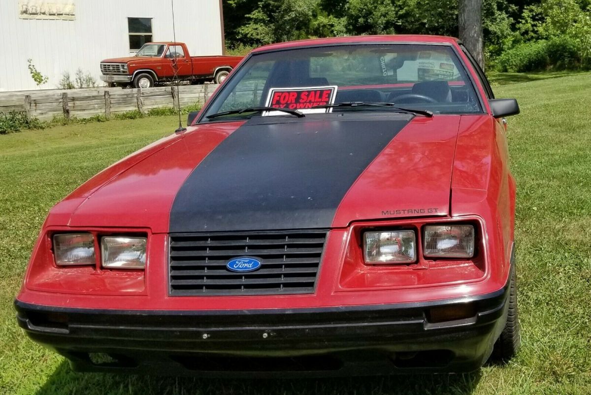 1984 Red Ford Mustang 2 dr sedan hatchback