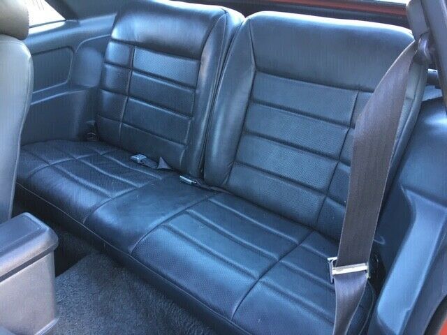 1985 red Ford Mustang Hatchback