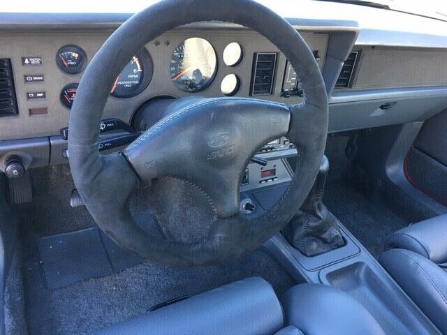 1985 red Ford Mustang Hatchback