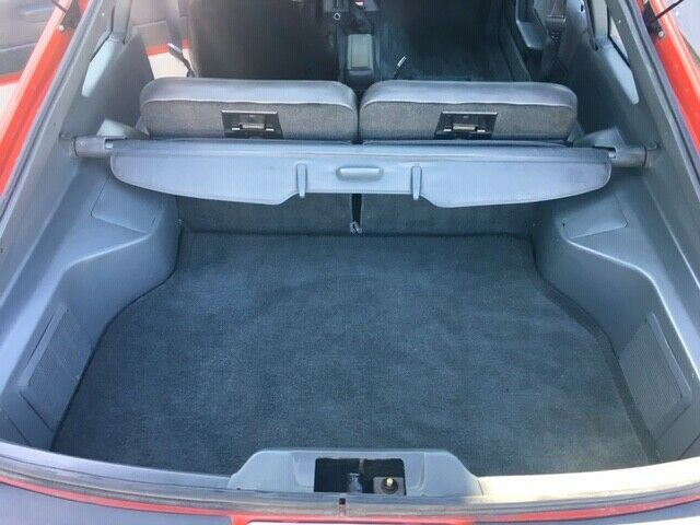 1985 red Ford Mustang Hatchback