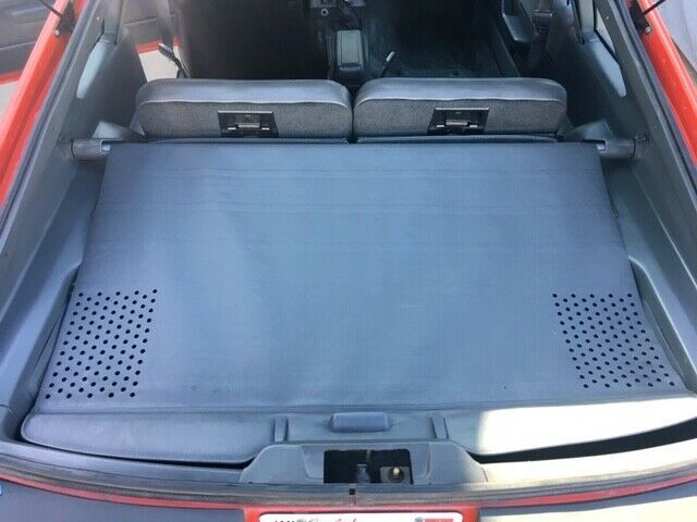 1985 red Ford Mustang Hatchback