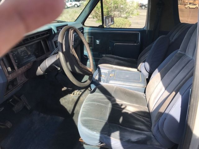 1985 blue and gray Ford Bronco 2door suv