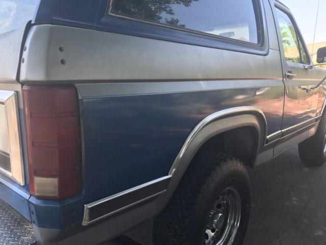 1985 blue and gray Ford Bronco 2 door bronco