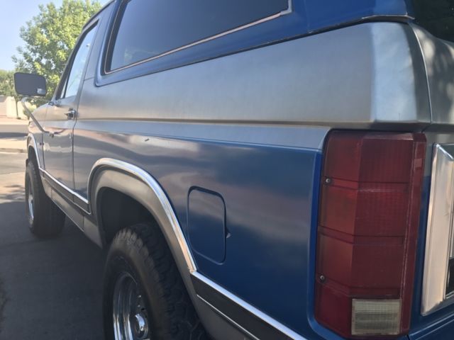 1985 blue and gray Ford Bronco 2 door bronco