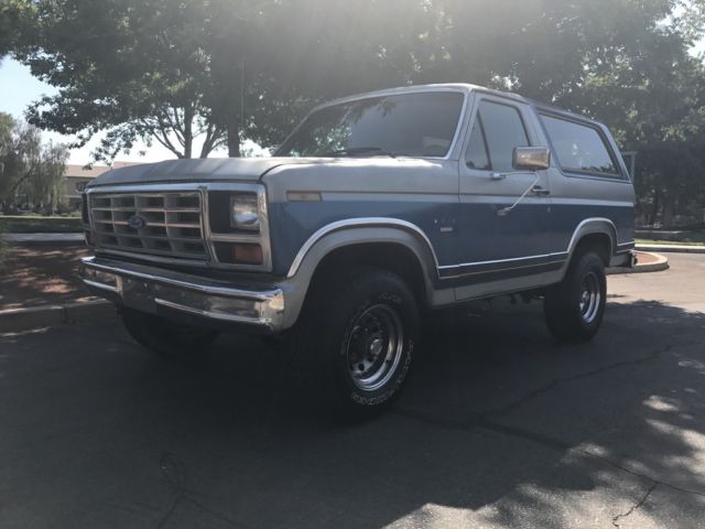 1985 blue and gray Ford Bronco 2 door bronco
