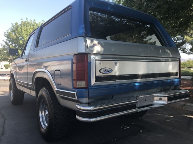 1985 blue and gray Ford Bronco 2 door bronco