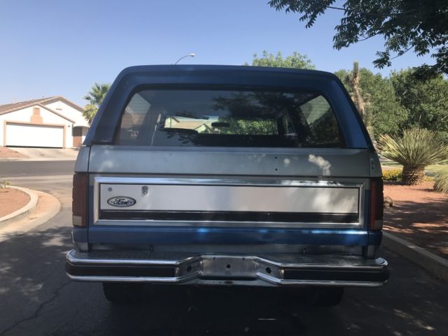 1985 blue and gray Ford Bronco 2 door bronco