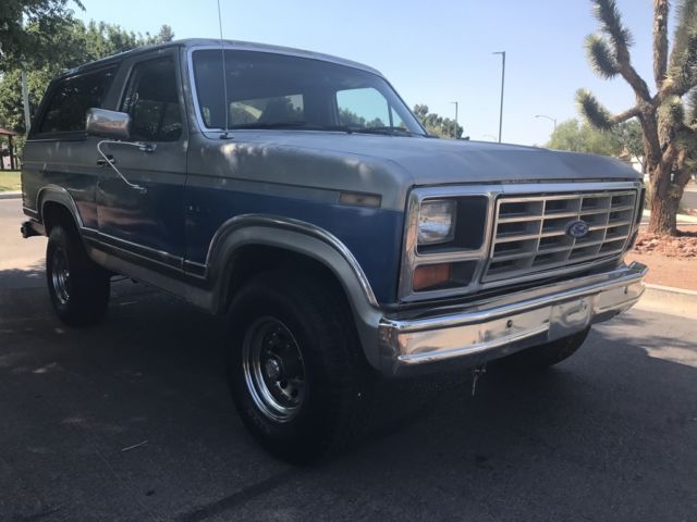 1985 blue and gray Ford Bronco 2 door bronco