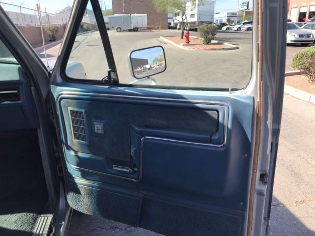 1985 blue and gray Ford Bronco 2door suv