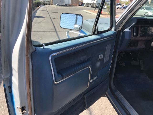 1985 blue and gray Ford Bronco 2door suv