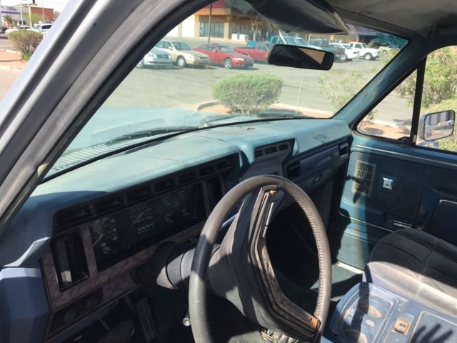 1985 blue and gray Ford Bronco 2door suv