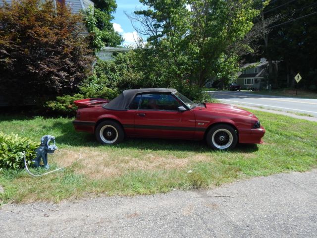 1986 deep red Ford Mustang Convertible