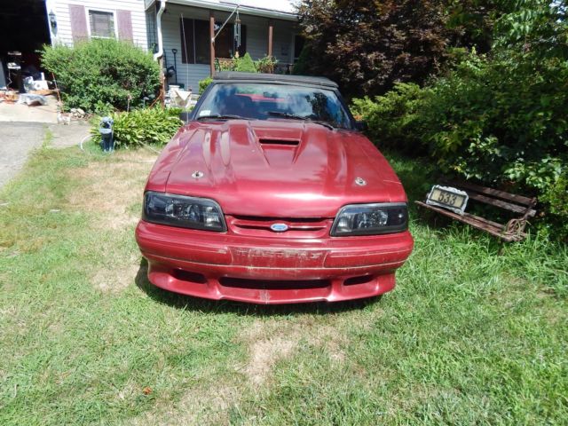 1986 deep red Ford Mustang Convertible