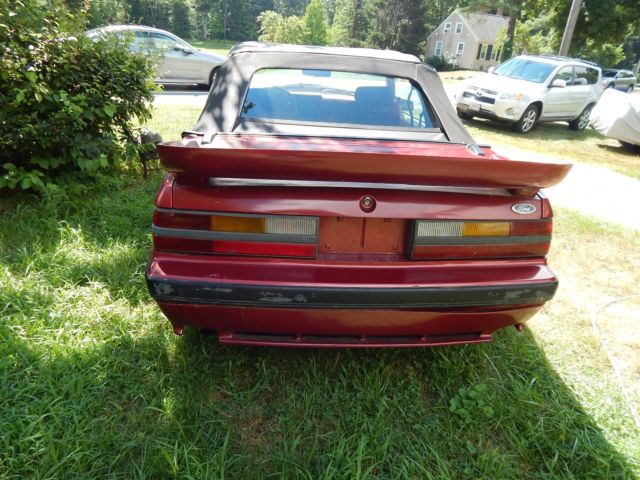 1986 deep red Ford Mustang Convertible