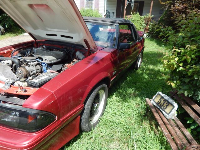 1986 deep red Ford Mustang Convertible