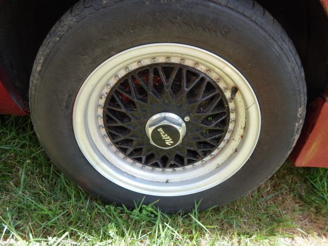 1986 deep red Ford Mustang Convertible