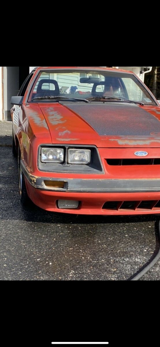 1986 Red Ford Mustang Sedan
