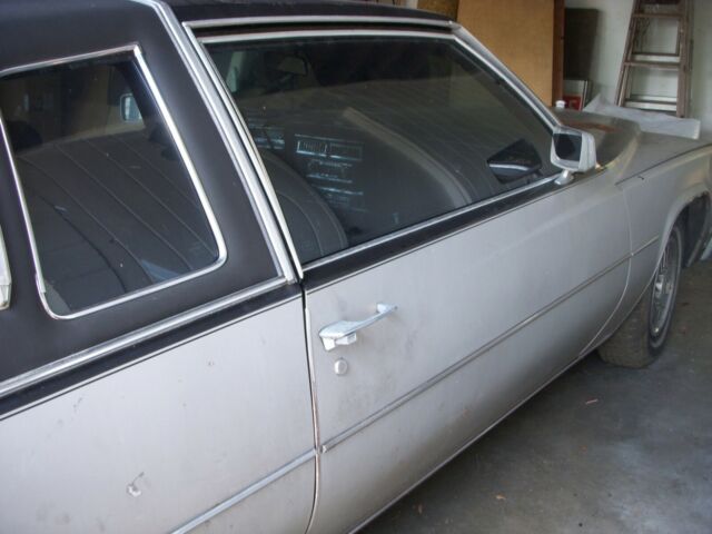 1978 grey and black Cadillac DeVille sedan