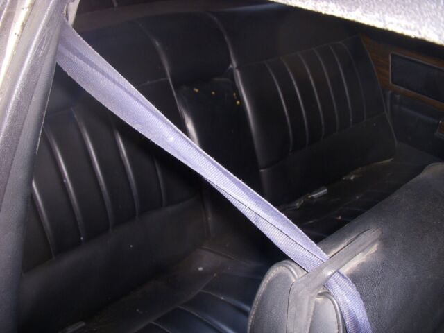 1978 grey and black Cadillac DeVille sedan