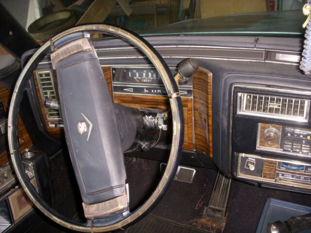 1978 grey and black Cadillac DeVille sedan