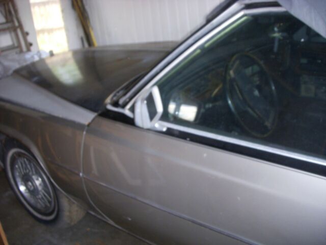 1978 grey and black Cadillac DeVille sedan