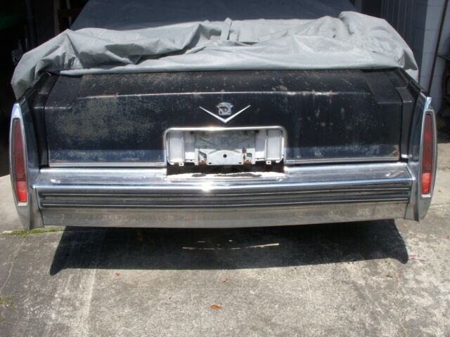 1978 grey and black Cadillac DeVille sedan