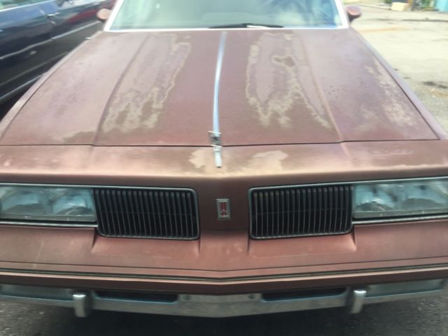 1987 Red Oldsmobile Cutlass Coupe