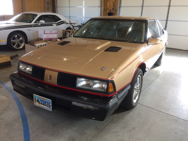 1987 Gold and black Oldsmobile Eighty-Eight Coupe