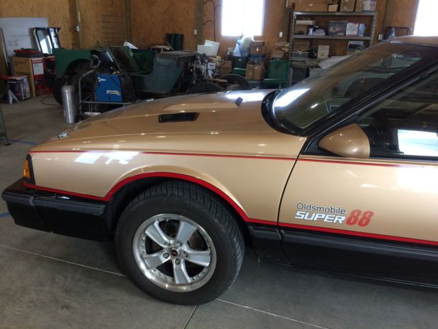 1987 Gold and black Oldsmobile Eighty-Eight Coupe
