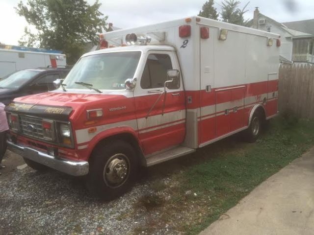 1987 red and white Ford E-Series Van full size fire ambulance ( retired)