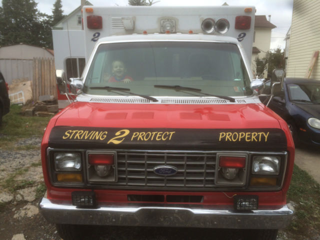1987 red and white Ford E-Series Van full size fire ambulance ( retired)