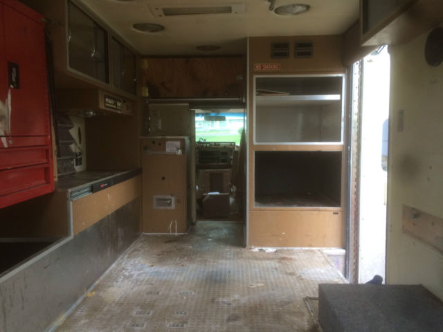 1987 red and white Ford E-Series Van full size fire ambulance ( retired)