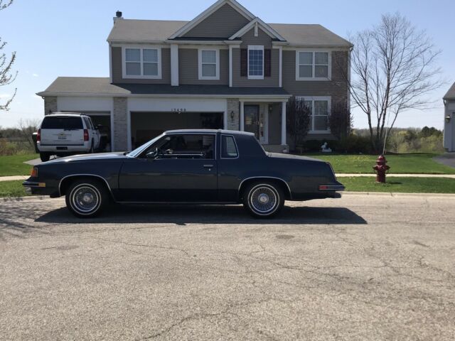 1988 blue Oldsmobile Cutlass Coupe
