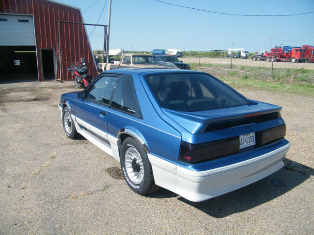 1988 black cherry Ford Mustang 2 dr