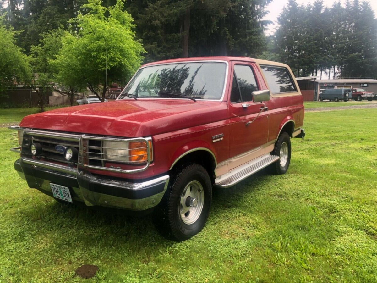 1989 Red and tan Ford Bronco SUV