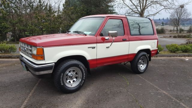 1989 red and white two tone Ford Bronco II SUV