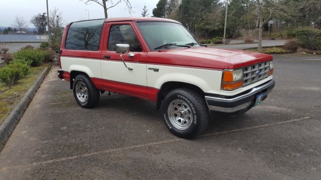 1989 red and white two tone Ford Bronco II SUV