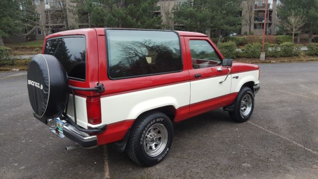 1989 red and white two tone Ford Bronco II SUV