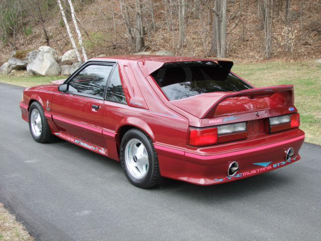 1989 red Ford Mustang Hatchback