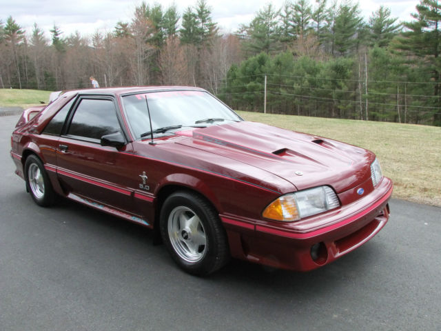 1989 red Ford Mustang Hatchback