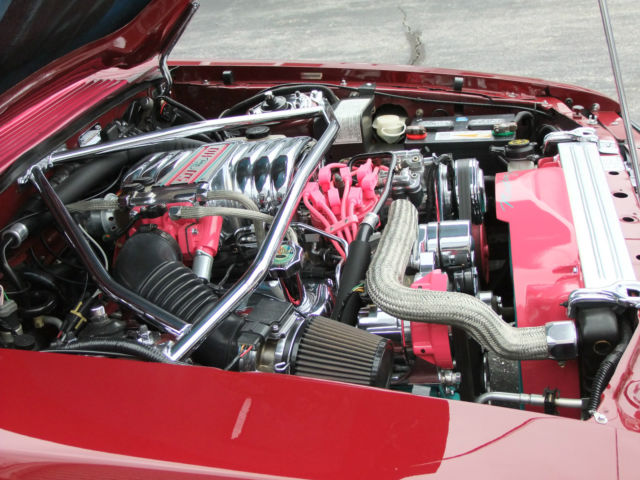 1989 red Ford Mustang Hatchback