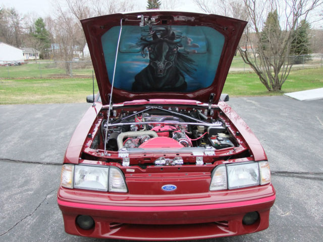 1989 red Ford Mustang Hatchback