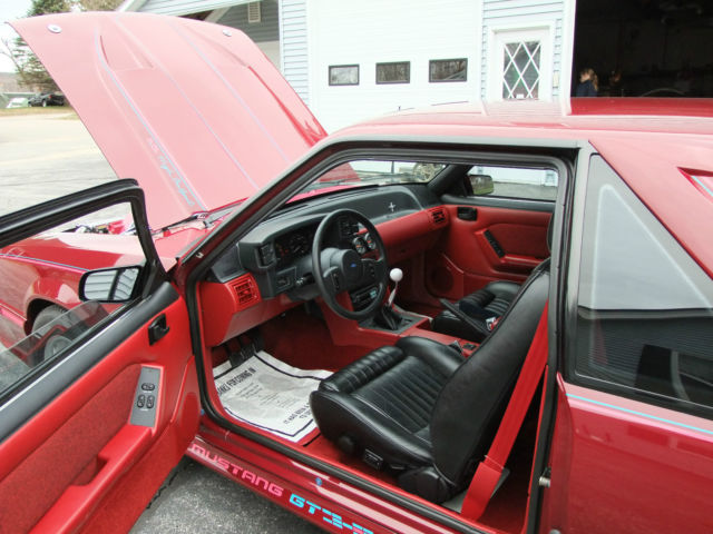 1989 red Ford Mustang Hatchback