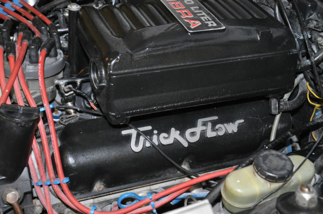 1989 Pearl White/Flat Black Ford Mustang Sedan