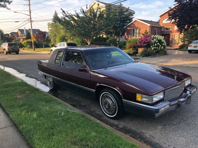1989 burgundy/dark red Cadillac Fleetwood Coupe