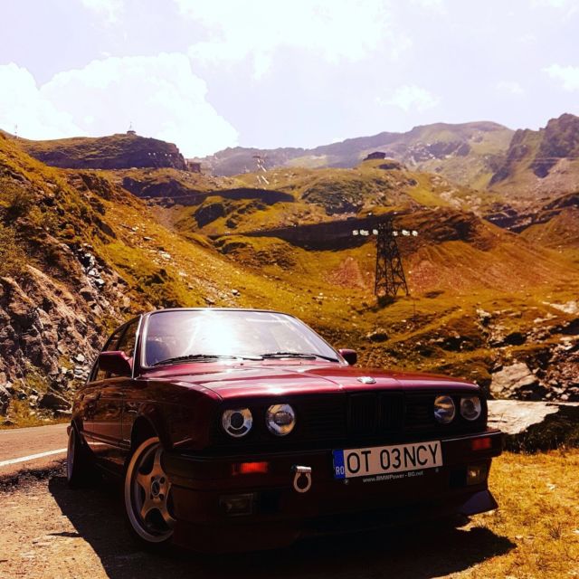 1990 dark red BMW 3-Series sedan