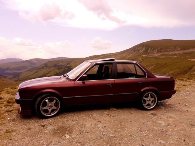 1990 dark red BMW 3-Series sedan